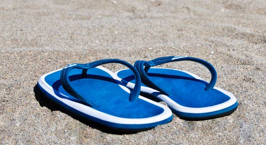 a pair of beach sandals on the sand