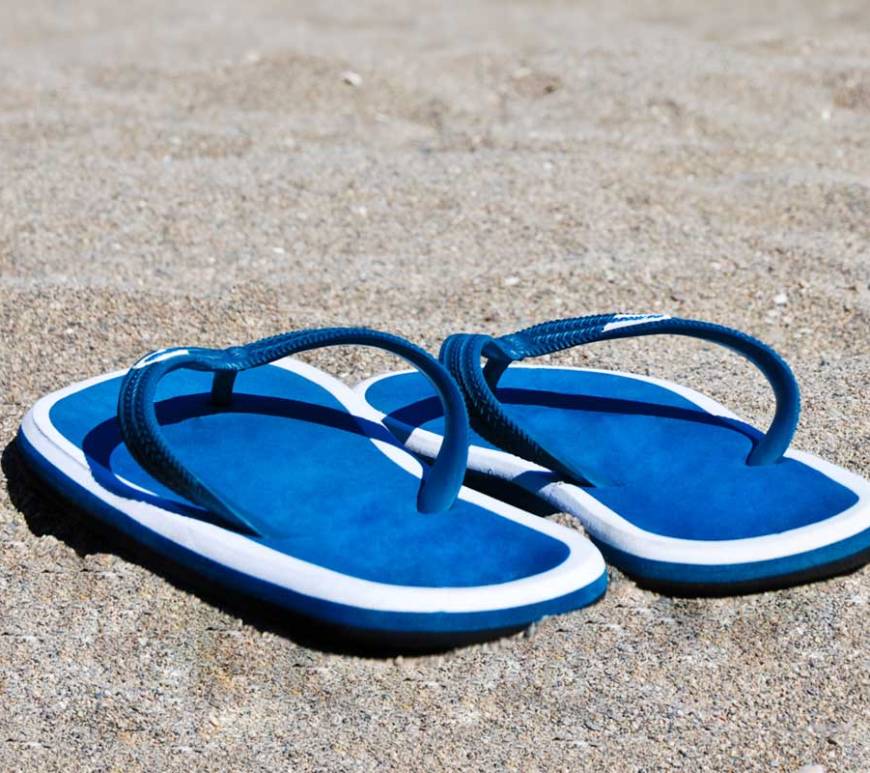 a pair of beach sandals on the sand